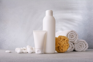 Obraz na płótnie Canvas Plastic cosmetic’s bottle and tube of cream and shampoo