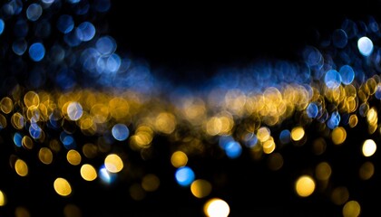 Abstract blue-gold bokeh on dark background.