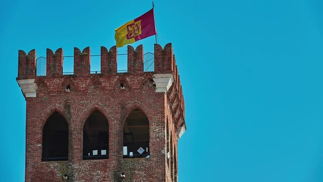 Civic Tower with red yellow flag on Piazza Garibaldi in Bassano del Grappa, Vicenza province of region of Veneto, in northern Italy.