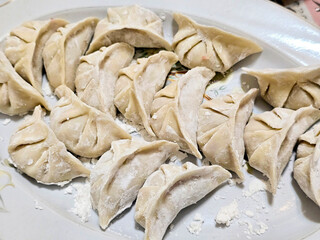 A close-up of Chinese dumplings that have not yet been cooked. (Jiaozi)