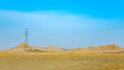 Jiuquan City, Gansu Province - Power tower, highway and Gobi scenery under the blue sky