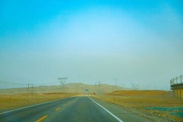 Jiuquan City, Gansu Province - Power tower, highway and Gobi scenery under the blue sky
