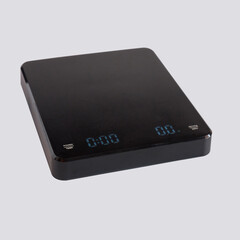 Black digital weighing scale for coffee beans measure.
