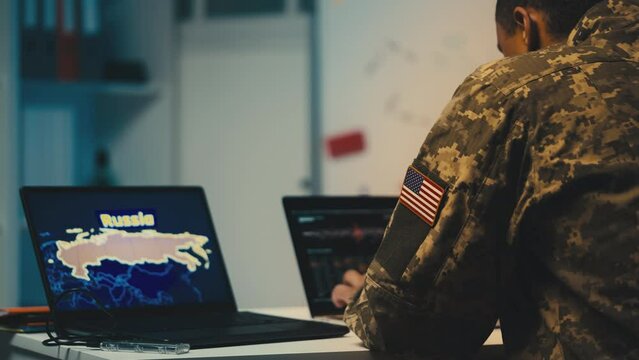 American military studying Russia map on computer, security threat assessment