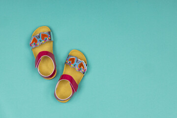 Cute sandals for kids on blue background. Little girl sandals