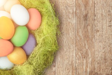 Composition with colored Easter eggs on wood background