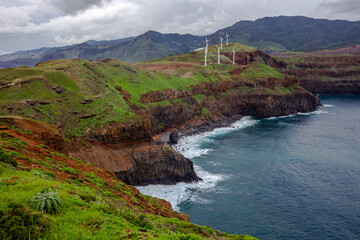 Rocky coast with wind farm from viewpoint - Ponta do Rosto - Madeira, Portugal