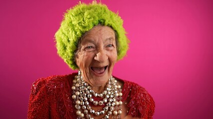 Excited successful happy fisheye view of funny elderly woman with no teeth and green hat isolated...