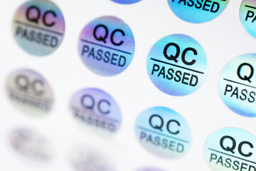 Close-up of stickers with text QC passed