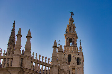 Fototapeta na wymiar Cathedral of Santa Maria de la Sede with Giralda in Seville, Spain. Travel and tourism concept. Catholicism and monuments.