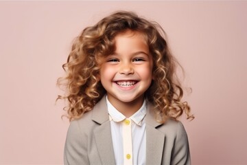 Portrait of a cute little girl with curly hair over pink background