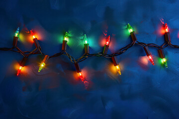 Christmas lights over dark blue background.