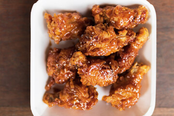 Deep fried chicken wing with spicy sauce in Korean style.