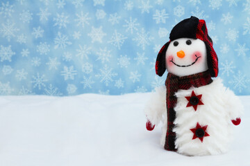 Snowman with hat and scarf with snowflakes
