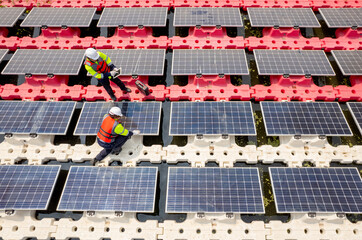 Close up and top side view of two technician workers check and maintenance solar cell panel over...