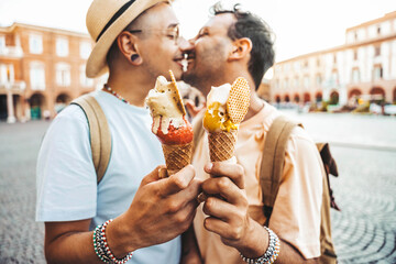 Gay couple in love eating ice cream on city street