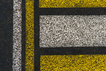 Road markings on wet asphalt. White yellow zebra for pedestrian safety. Pedestrian crossing. A copy place.