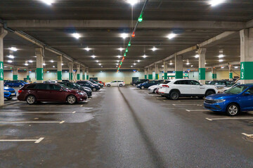 Covered guarded and safety parking with cars. Underground parking for cars. Parking lot. Selective focus, blurred background.
