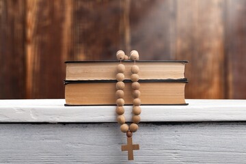 Dramatic light shining on bible book with a rosary