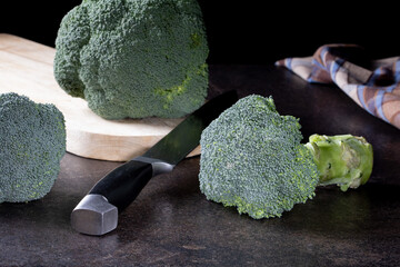 Fresh Green Broccoli Florets on Cutting Board with Knife. Healthy Organic Vegetables for Cooking.