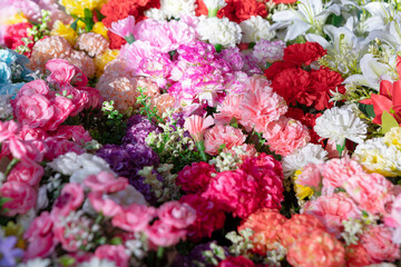 Colorful artificial flowers background, in bloom 