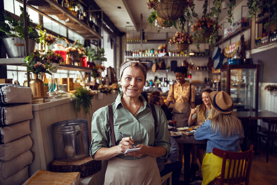 Portrait of a middle aged waitress in a restaurant