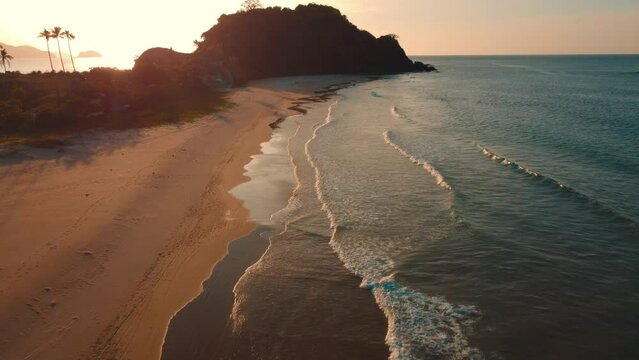 Aerial 4k view sunset over Nacpan Beach, El Nido, The Philippines. Beautiful scenic cinematic views.