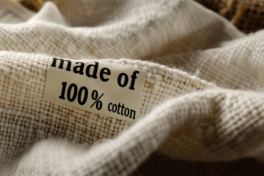 Sustainable Fabric: Close-Up of Organic Cotton Textile with Eco-Friendly Label with text "Made of 100% Cotton".