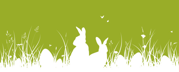 Easter banner with Easter bunnies and Easter eggs on the grass. Green Easter background - 734053369