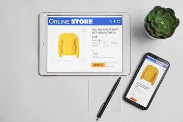 Online shopping. Flat lay composition with modern tablet and smartphone on white background