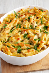 Homemade Cheesy Chicken Alfredo Pasta Bake in a Dish, side view.
