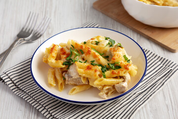 Homemade Cheesy Chicken Alfredo Pasta Bake on a Plate, side view.
