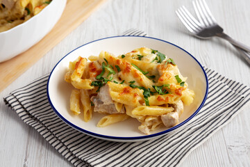 Homemade Cheesy Chicken Alfredo Pasta Bake on a Plate, side view.