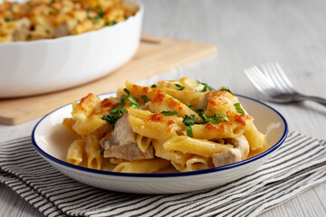 Homemade Cheesy Chicken Alfredo Pasta Bake on a Plate, side view.