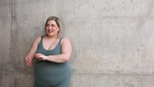 portrait of curvy woman posing to show power and strength of woman. Concept of curvy female body, body positive and empowered, body acceptance