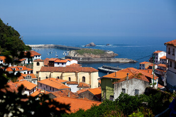 Naklejka na ściany i meble View of Cudillero, typical Asturias fishing village with the port in the background