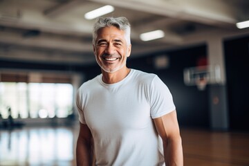 Smiling portrait of a senior man in the basketball gym