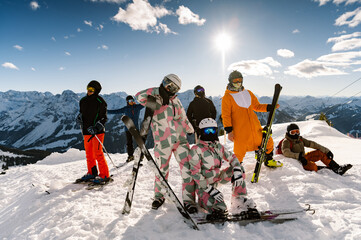 Group of happy friends having fun at the ski resort. Skiers and snowboarders team concept. friends...