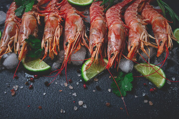 Langoustines, Australian, freshly frozen on ice, top view, lime and greens,