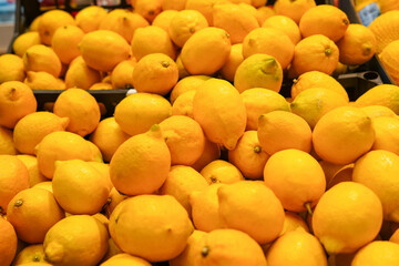 Ripe Yellow Lemons Close-up Background Or Texture. Lemon Harvest, Many Yellow Lemons in the store