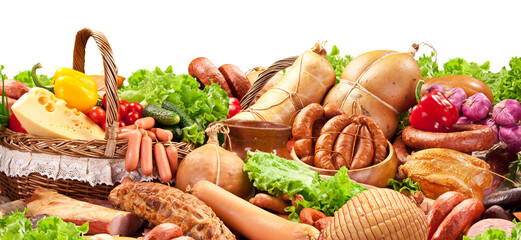 Varied assortment of prepared meats and sausages with vegetables and herbs. Wonderful food...