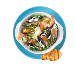 Bowl of seafood cream-soup  with mussels and prawns isolated on a white background, top view.