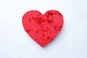 One velvet heart on white background, top view