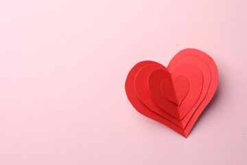 Paper hearts on pink background, top view. Space for text