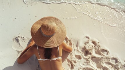 A woman relaxing on the beach wearing a straw hat. Perfect for travel or vacation-related projects