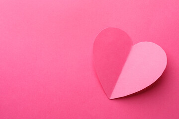 Fototapeta premium Paper heart on pink background, top view. Space for text