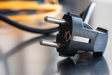 Electric plug close-up with power supply cord cable