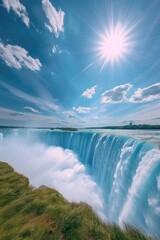 The sun shines brightly over a large waterfall. Ideal for nature and landscape photography.