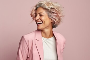 Portrait of a happy mature woman with short blonde hair smiling over pink background - Powered by Adobe