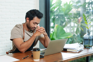 Businessman, cafe owner, small business, multiethnic man working with laptop, contemplating...